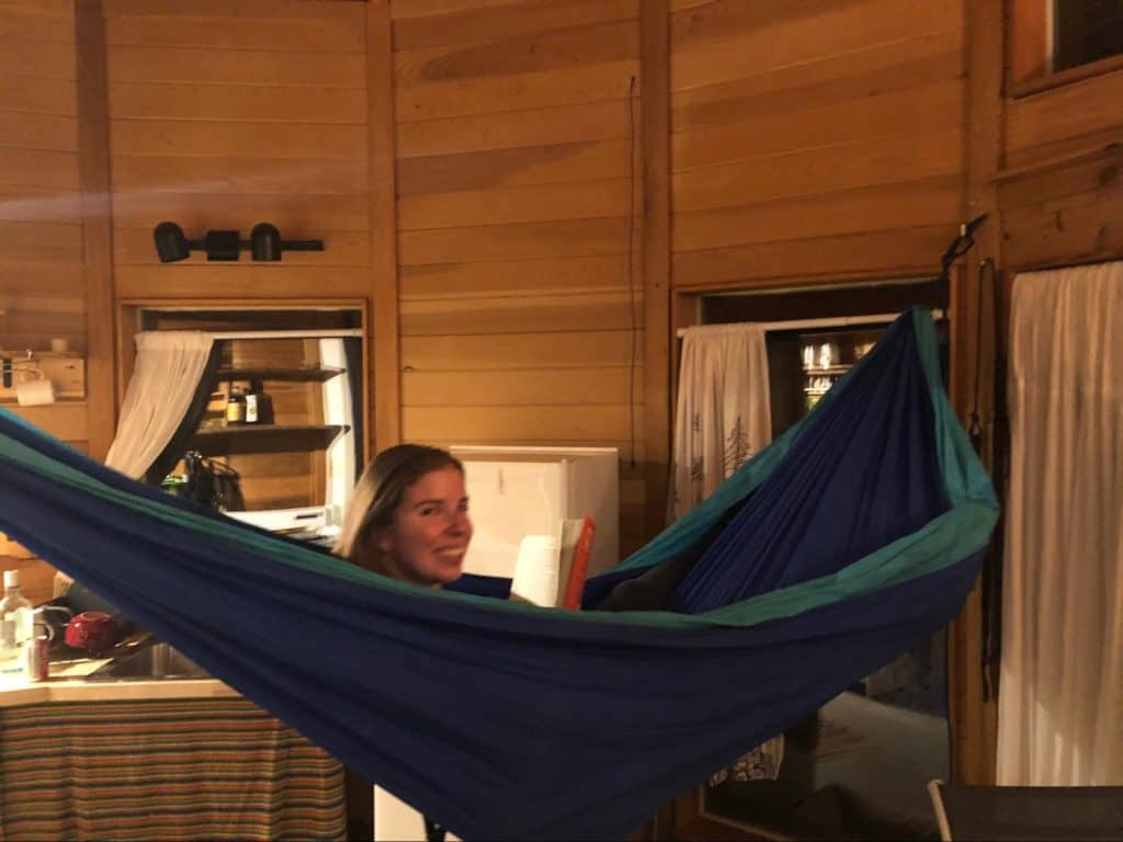 Maddy reading a book in a hammock